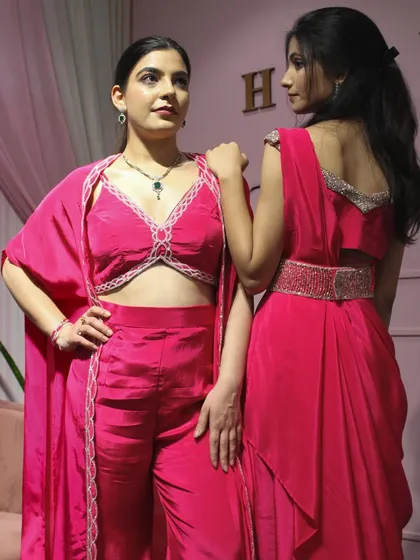 A back and front view of our pink fusion wear, including a co-ord set with a cape and a draped saree with an embellished belt.