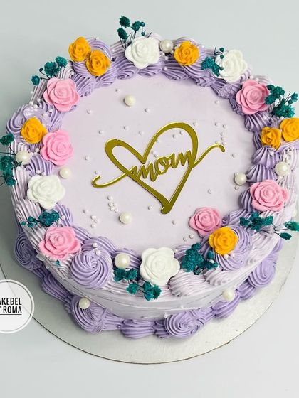 An elegant floral cake for mom, with a beautiful "Mom" heart topper.