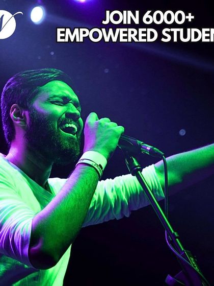 Join a legacy of over 6,000 empowered students. This vocalist is captured during a powerful live performance, a testament to the confidence and skill gained at our school.