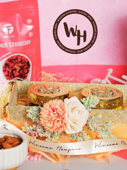 A detailed shot of the gourmet items in a festive hamper. This image focuses on the Chatpata Cranberry pack, Davidoff coffee, and decorated jars, highlighting the premium quality of the products I select.