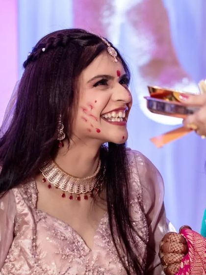A fun and candid moment from the Haldi ceremony. The bride's laughing reaction to being smeared with haldi is priceless.
