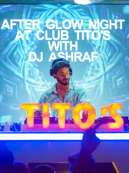 A clear shot of me at the helm during a themed night at Tito's. My setup includes my laptop and Pioneer controller, ready to deliver a custom set.