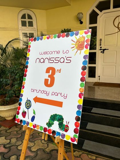 Welcome to the party. I coordinate with decorators to ensure my food setup, including signage, matches the overall theme, like this 'Very Hungry Caterpillar' birthday.