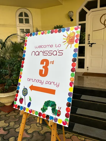Welcome to the party. I coordinate with decorators to ensure my food setup, including signage, matches the overall theme, like this 'Very Hungry Caterpillar' birthday.