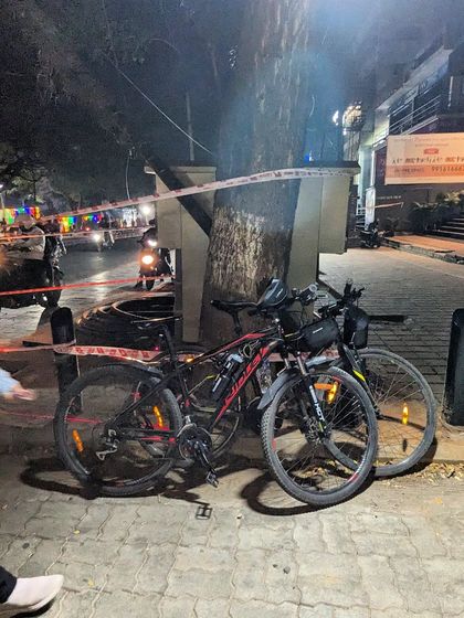 Two bikes parked amidst the New Year's Eve crowds. Even in the chaos, our cycles stand as a testament to a different way of celebrating.