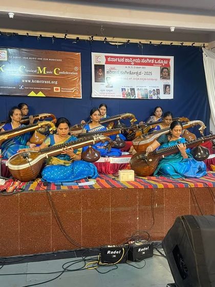 A wider shot of the student ensemble performance at Malleswaram Ramamandira, accompanied by mridangam and ghatam. Learning to play with percussion is a key part of our performance training.