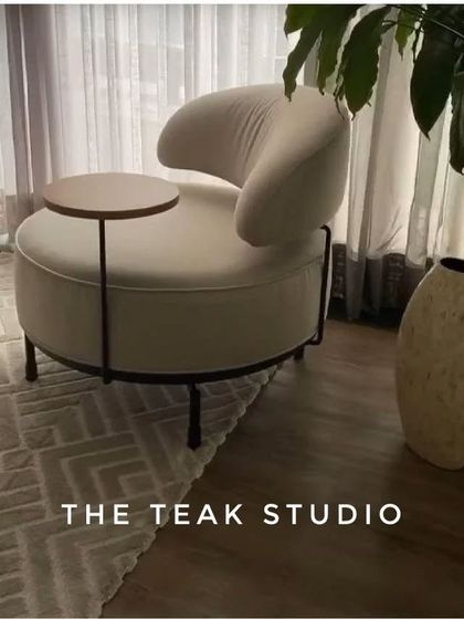 We love this design for a modern accent chair with an attached side table. It's a smart, space-saving solution that is perfect for a cozy reading nook or a compact living area.