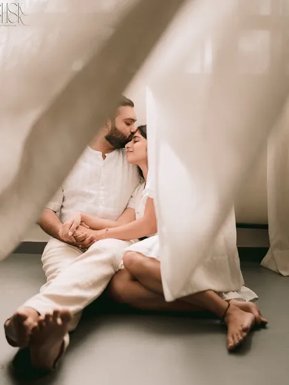 Sometimes, the most powerful stories are told in the quietest settings. This intimate studio session, with just soft light and simple white curtains, was about creating a space where the couple could feel completely at ease. It’s a tender, peaceful moment of togetherness.