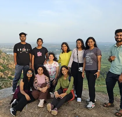 A group of friends enjoying the sunset views from Kunti Betta.