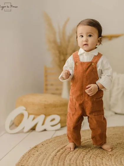 A proud moment as the birthday boy stands on his own. We capture all these big firsts during our milestone sessions.