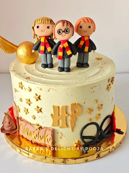 Another angle of the magical Harry Potter cake, showcasing the golden snitch, sorting hat, and other iconic details.
