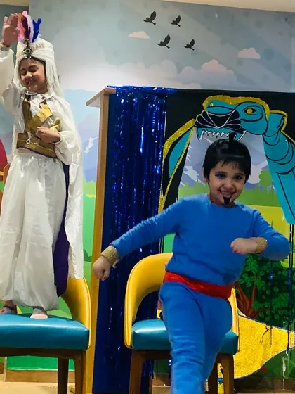 Two young actors, playing Genie and Aladdin, bring energy and fun to their scene.