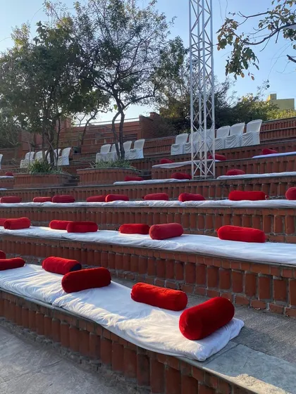 For a cultural function at the Bhandarkar Institute, we arranged traditional 'baithak' seating with mattresses and red bolsters in the amphitheater.
