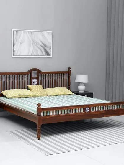 A classic king-sized bed frame made from solid Sal wood. This design features traditional turned legs and a spindle headboard, showcasing my team's skill in timeless woodworking.