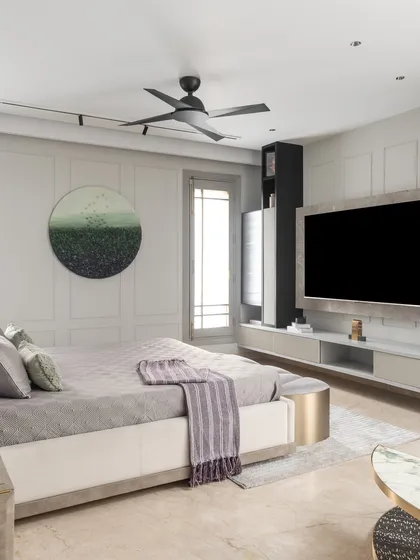 A full view of the master bedroom, showcasing the curved bed frame and the cohesive design of the furniture and decor. The space feels calm, inviting, and full of character.