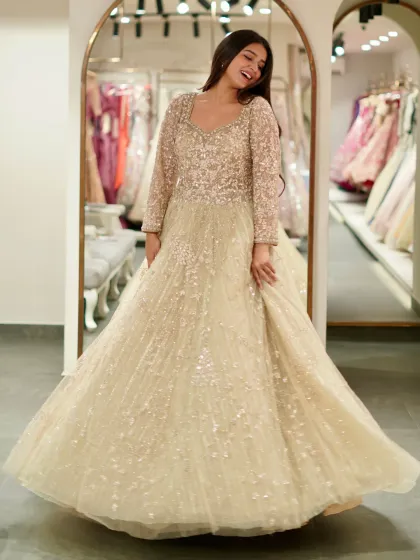 For your reception or engagement, imagine walking in wearing this. This beige gown is pure fairytale, covered in sparkle that catches the light with every move you make. It’s designed for that unforgettable twirl on the dance floor.
