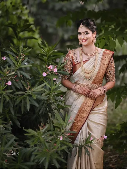 Our client looks stunning in her bridal attire, a classic silk saree that perfectly complements her grace and poise on her wedding day.
