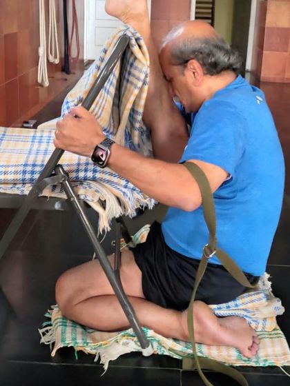 A deep seated forward bend with a chair.