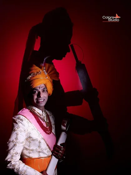 A creative groom's portrait with a shadow of him holding a cricket bat, showing a personal touch and his interests.