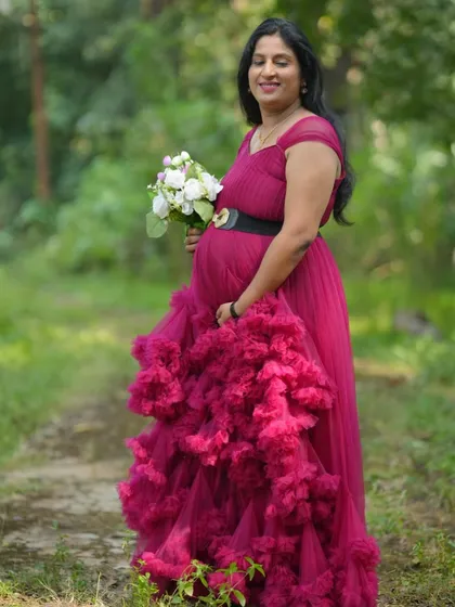 This wine-colored gown with a dramatic ruffled skirt is a showstopper. It's perfect for a mom-to-be who wants a bold and fashionable maternity shoot.