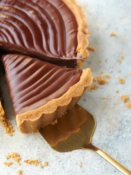 A perfect slice of my Signature Chocolate Tart. The rich, dark chocolate filling and crumbly, buttery crust create a simple yet elegant dessert that is a favorite for any occasion.