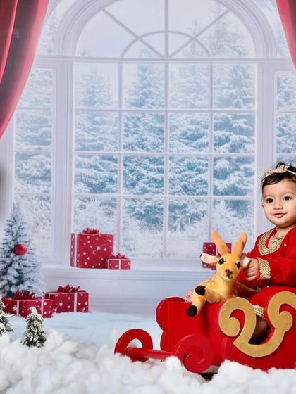 A beautiful portrait of a baby girl in her Christmas sleigh, creating a magical holiday card photo.