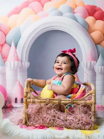 Every princess deserves a castle. This colorful balloon castle setup creates a magical fairytale world for this happy baby girl.