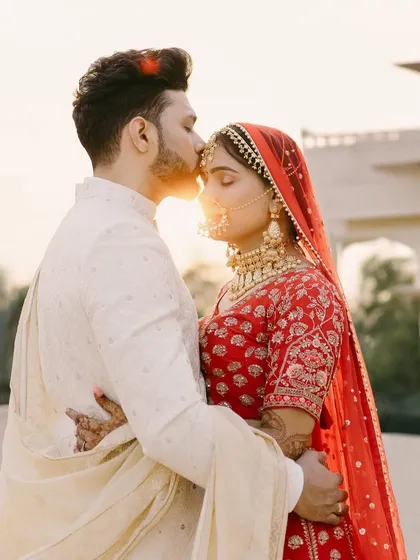 We are honored to be a part of your most cherished moments. This real wedding portrait captures the timeless elegance of our classic ivory sherwani, designed to complement the joy of the day.