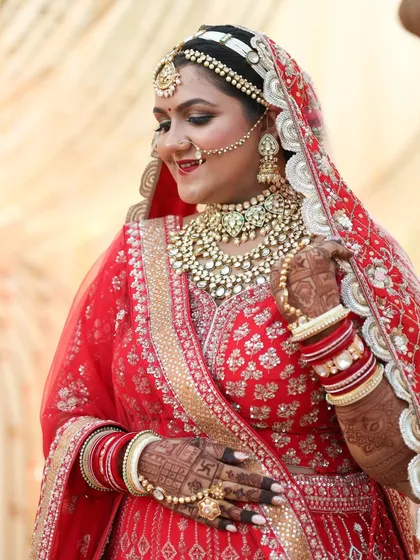 The joy of a bride on her wedding day. This close up shows her radiant smile and the beautiful harmony between the heavy kundan jewelry and the classic bridal makeup, featuring a smokey eye and a traditional bindi.