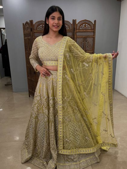A lovely lime green lehenga with all-over silver embroidery. This pre-loved piece is fresh, vibrant, and perfect for a mehendi or sangeet.