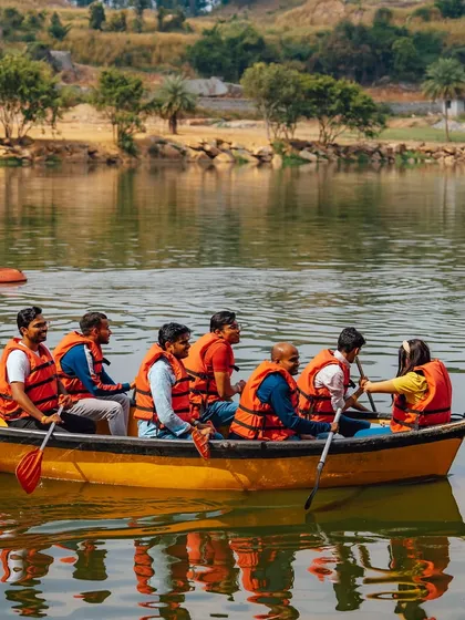 A team enjoys a boat ride together, paddling in sync and enjoying the beautiful scenery of the lake.