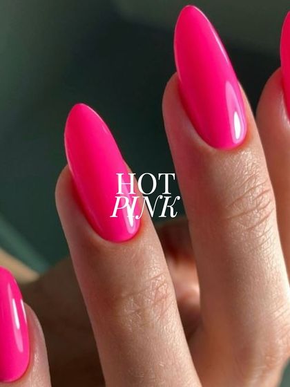 A close-up of this electrifying hot pink. The color is incredibly saturated and the application is flawless, creating a smooth, high-shine finish on these elegant almond-shaped nails.