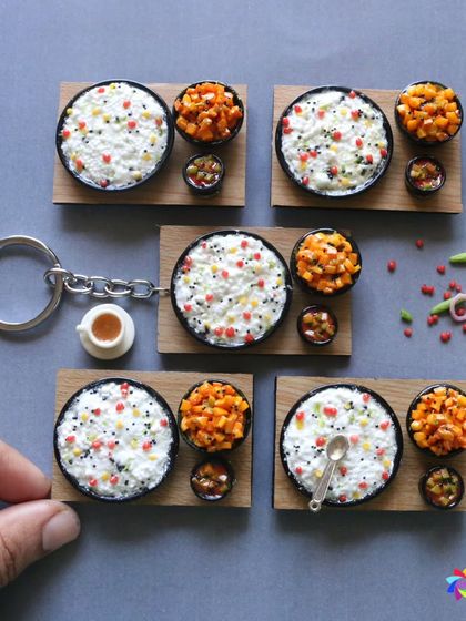 A collection of curd rice miniatures, some as keychains and others as standalone pieces.