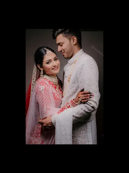 A beautifully composed portrait of a North Indian couple, framed to create an intimate and classic feel.