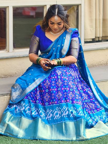 Beauty beyond words in blue. This bride's pre-wedding look features a stunning blue lehenga saree, paired with soft makeup and a simple, elegant hairstyle.