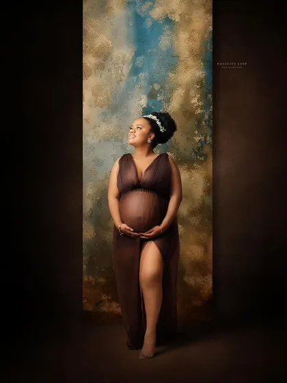 A hopeful and radiant portrait of a mother-to-be. Her upward gaze and the beautiful lighting create a feeling of anticipation and joy.