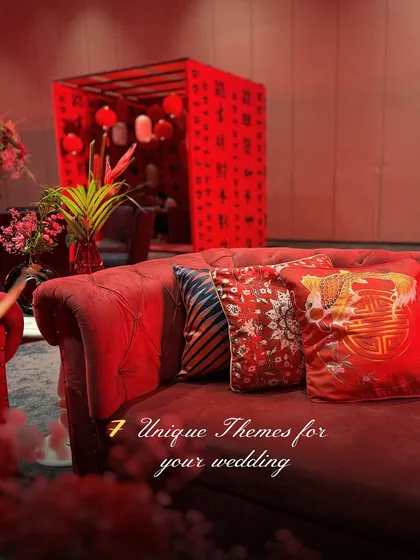 A glimpse into our "7 Unique Themes," with this image highlighting the rich textures and bold red of the Tokyo-inspired decor, featuring patterned cushions on a classic Chesterfield sofa.