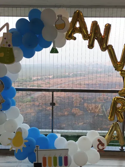 Our Science theme balloon ring, complete with scientist and beaker cutouts, set against a beautiful city view.