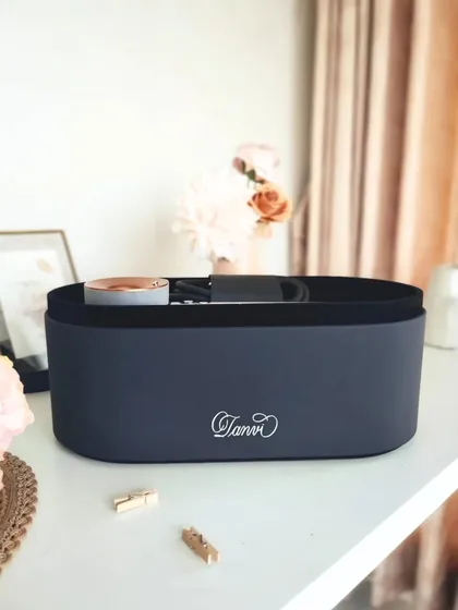 The personalized Dyson hairdryer case, styled on a desk. This shows how a touch of calligraphy can transform a high tech product into a piece of personal art.