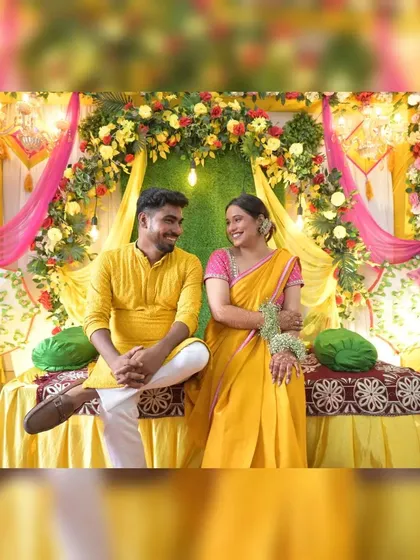 A lovely portrait of the couple seated together during their Haldi ceremony. This image shows their relaxed chemistry and also gives a full view of the beautiful floral and fabric decor I can provide.