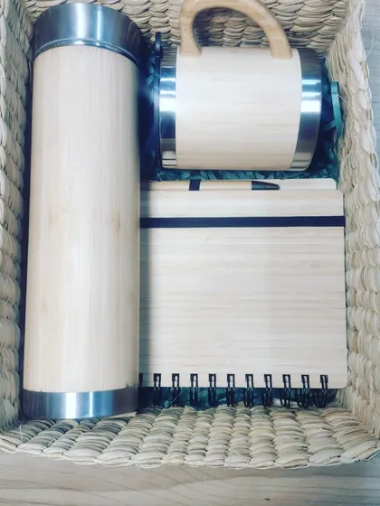 This is an example of our curated sustainable corporate gift sets. This employee joining kit features a bamboo flask, a bamboo mug, and a bamboo diary with a pen, all thoughtfully arranged in a reusable cane grass basket, ready for custom branding.