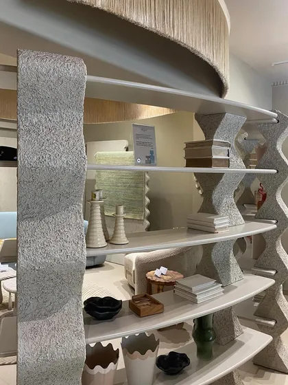 This unique, wave-like bookshelf at the JOSMO store is crafted from textured stone. It serves as both a functional display for decor and a central art piece, demonstrating our ability to blend furniture design with sculptural form.
