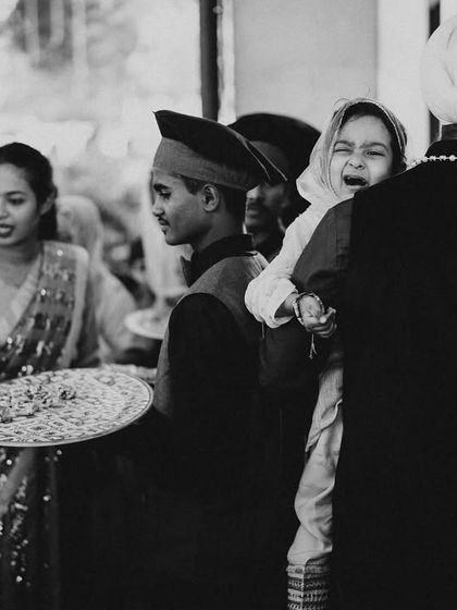 A candid black and white shot capturing the range of emotions in a crowd. From a crying child to smiling guests, it’s a real, unscripted slice of wedding life.
