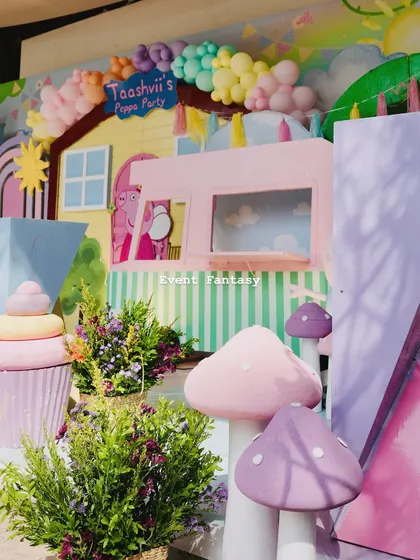 A close-up of the details in the Peppa Pig world, including colorful mushroom props and a part of the ice cream truck.