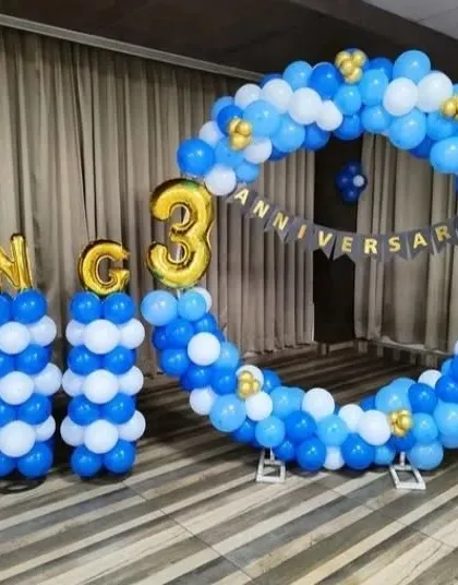 A corporate 3rd-anniversary celebration for LNC. The setup features a large circular balloon arch and balloon columns in the company's blue and white colors.
