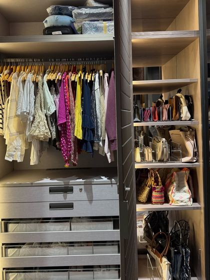This image shows how different storage types can coexist beautifully, with hanging clothes, drawers, and open shelving for bags and makeup.