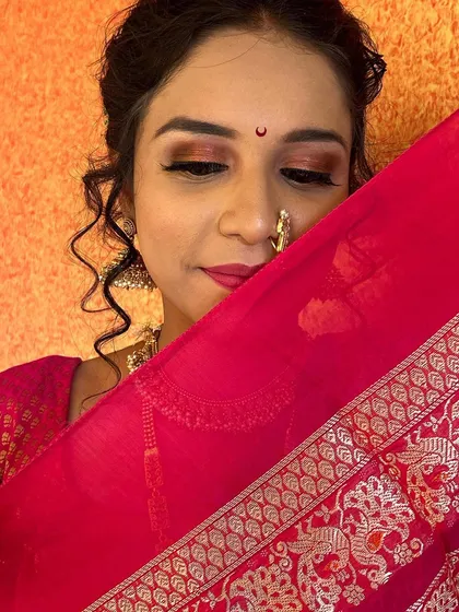 A coy and beautiful shot, with the saree's 'padar' adding a touch of traditional grace. The eye makeup is the focus here.