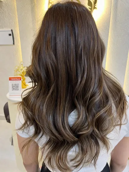 The back view of this beige ashy brown colour, showing the beautiful dimension and healthy shine of the hair.