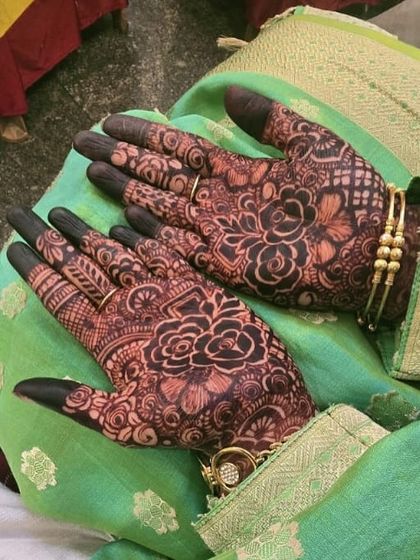 The rich, dark stain on the palms looks striking against the green fabric. This is the kind of color that makes your wedding photos look incredible.