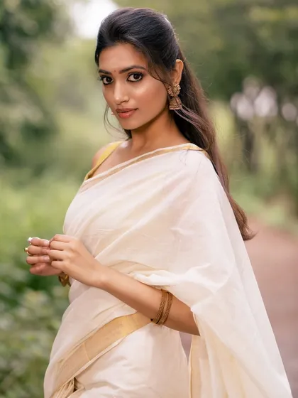 A profile shot of the model, highlighting her features and the elegant simplicity of her attire.